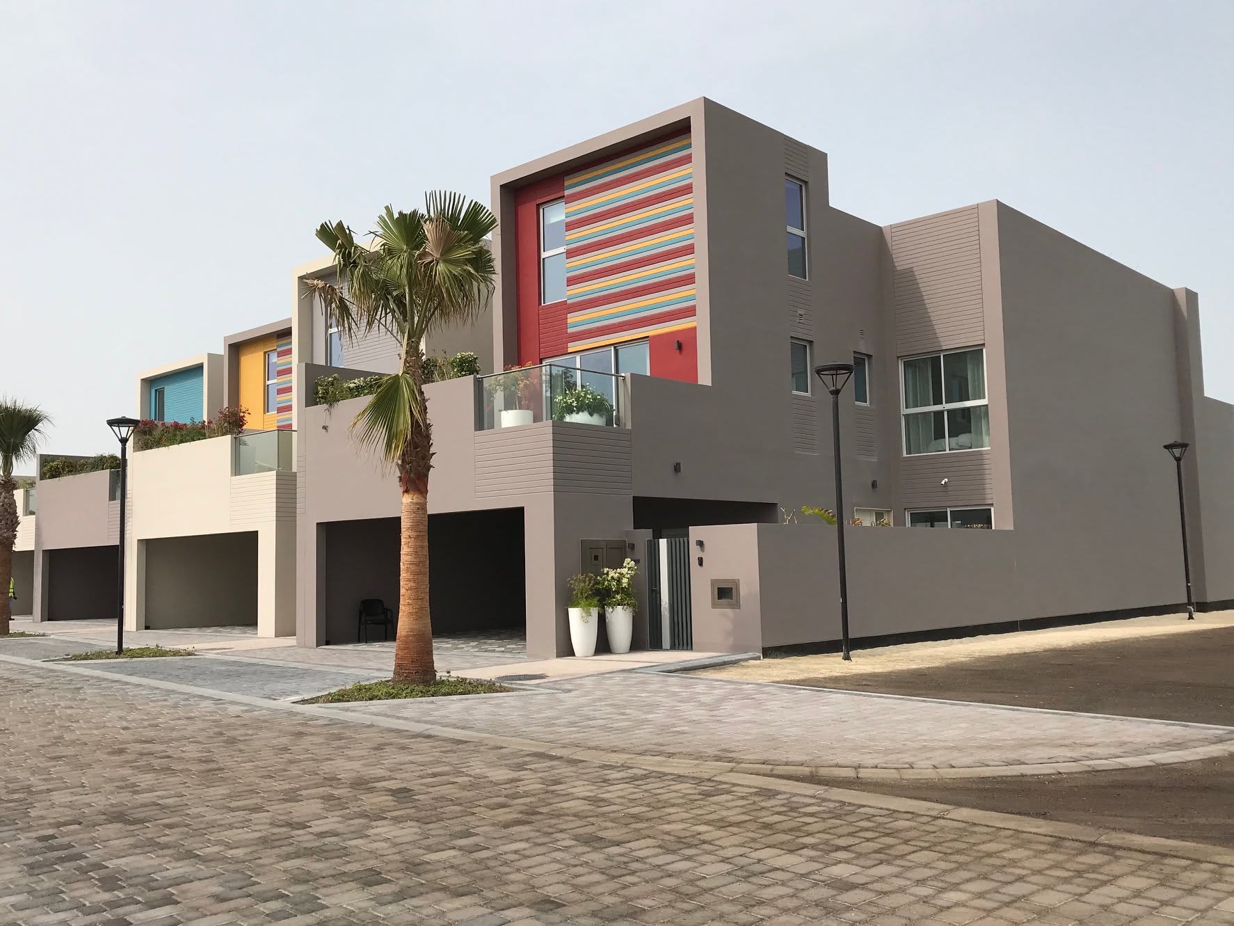Corner view of modern villas and palms